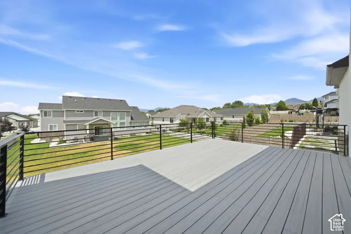 Spacious elevated deck featuring composite decking and sleek horizontal metal railings