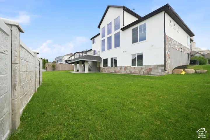 Expansive green lawn bordering a concrete privacy wall