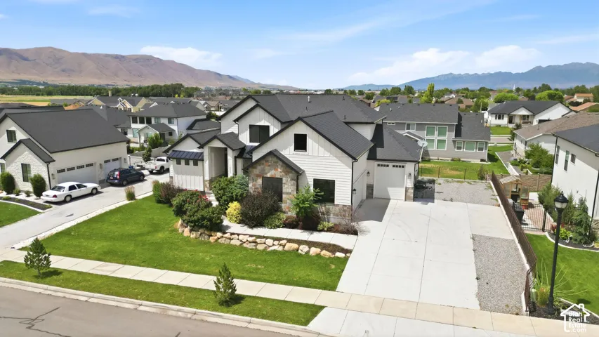 Contemporary two-story residence featuring a white siding and stone fa