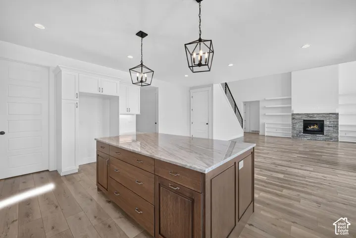 Kitchen island with a light-toned countertop and wood-finish cabinetry