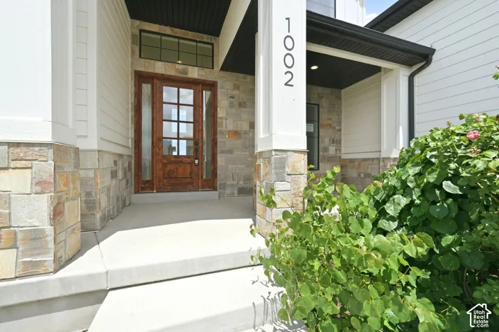 Crafted wood-paneled entry door with glass inserts and transom window