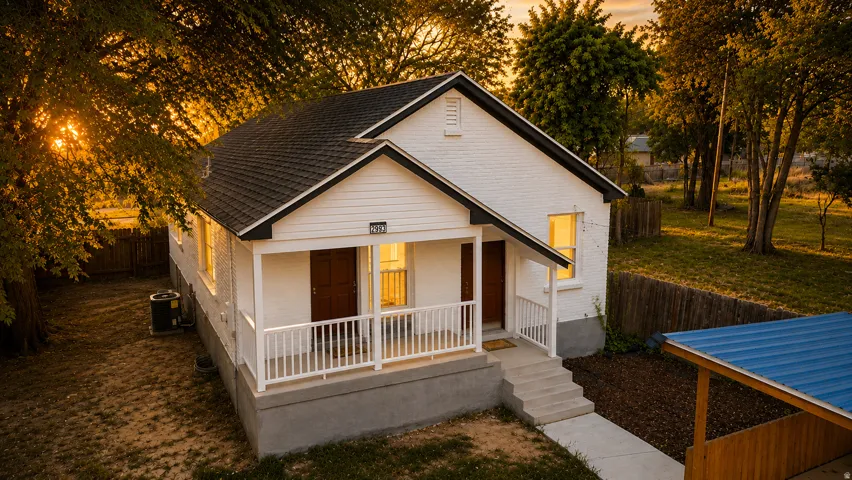 White brick and siding exterior with a dark shingle roof