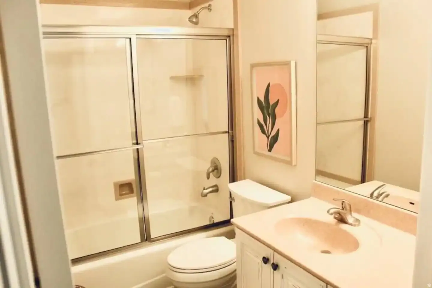White vanity with dual-door cabinetry, an integrated countertop, and an oval sink