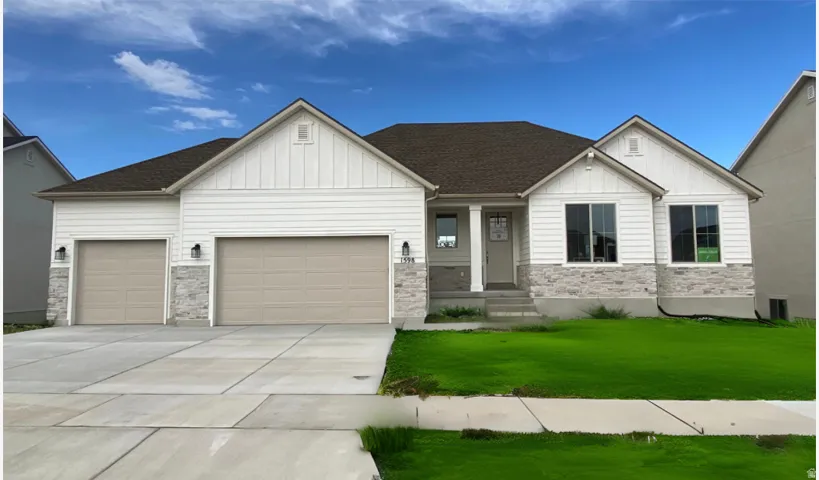 Contemporary ranch-style residence featuring a prominent two-car garage and an additional single-car garage