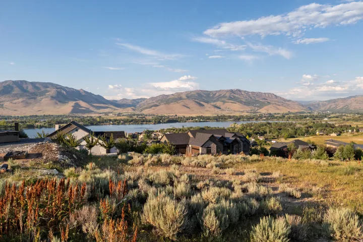 Expansive landscape featuring distant mountains and a large body of water