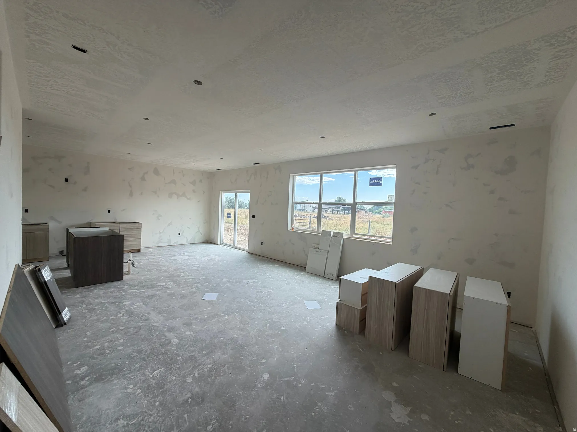 Spacious interior with large windows and a sliding glass door