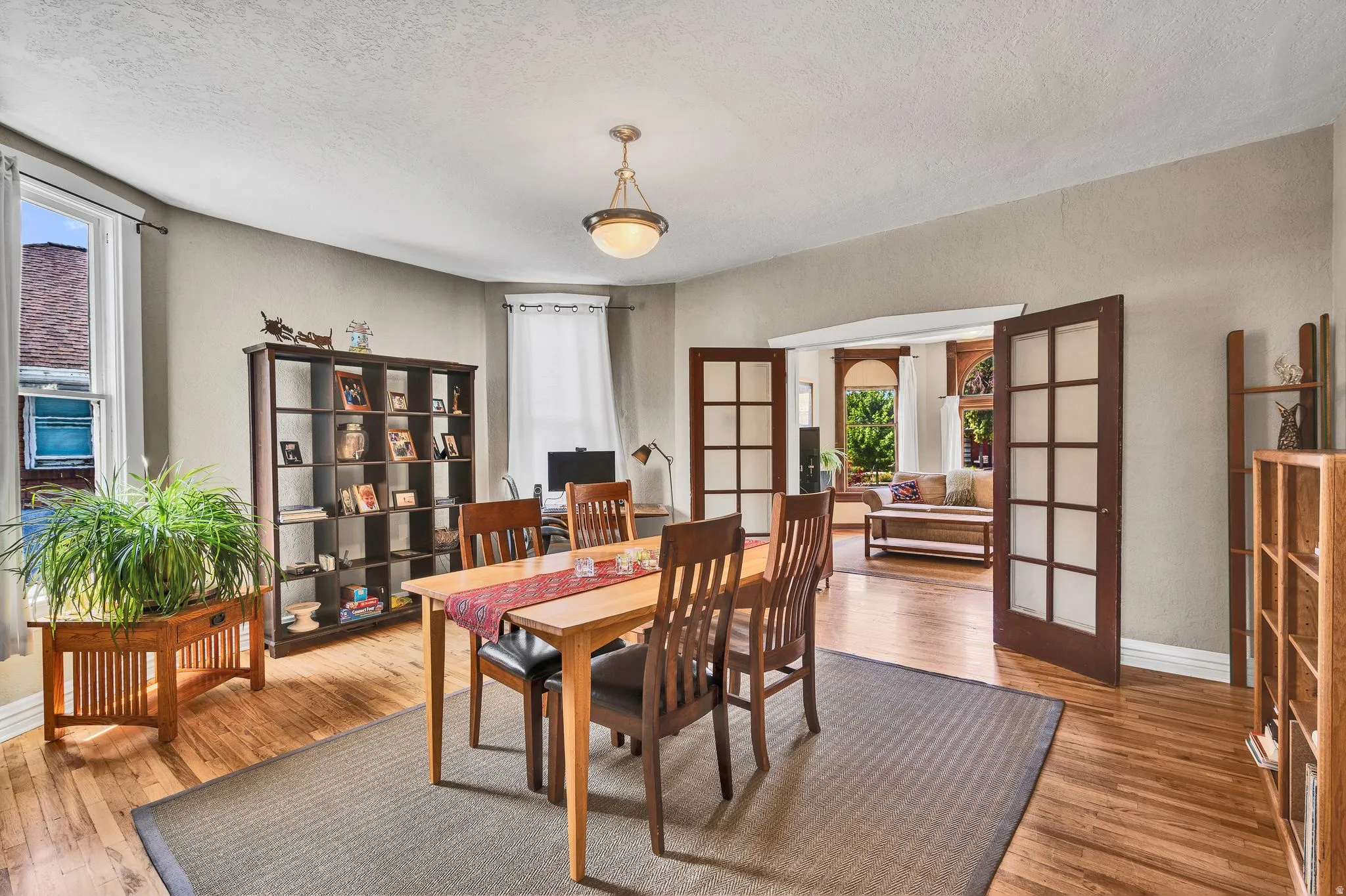 Spacious dining room with hardwood floors, and a beautiful bay window.