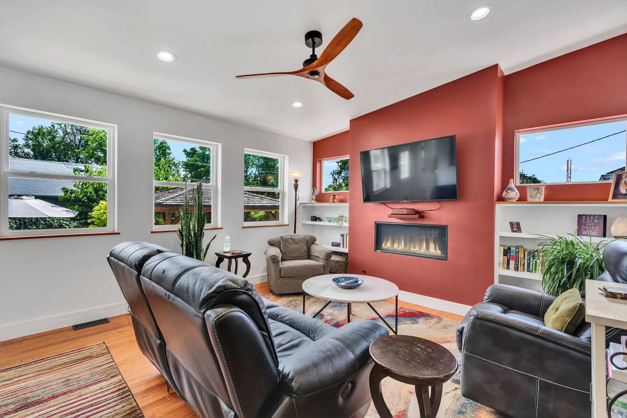 Living area featuring wood-finish flooring, recessed lighting, and a modern ceiling fan