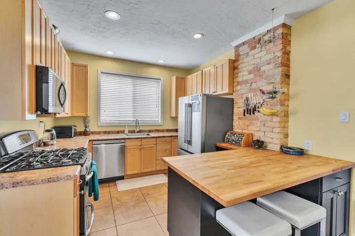 Kitchen featuring a stainless steel range, built-in microwave, and a stainless steel dishwasher
