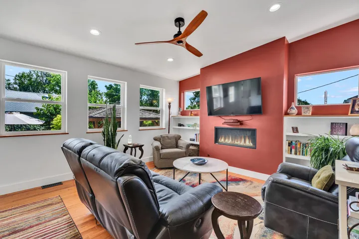 Living area featuring wood-finish flooring, recessed lighting, and a modern ceiling fan