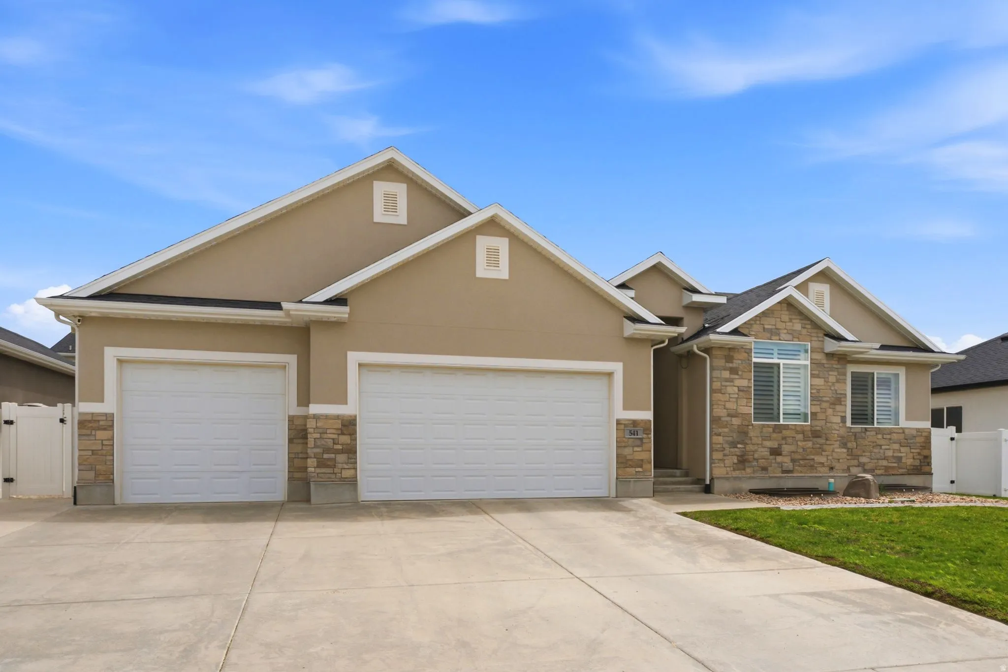 Contemporary exterior featuring stone accents and stucco siding