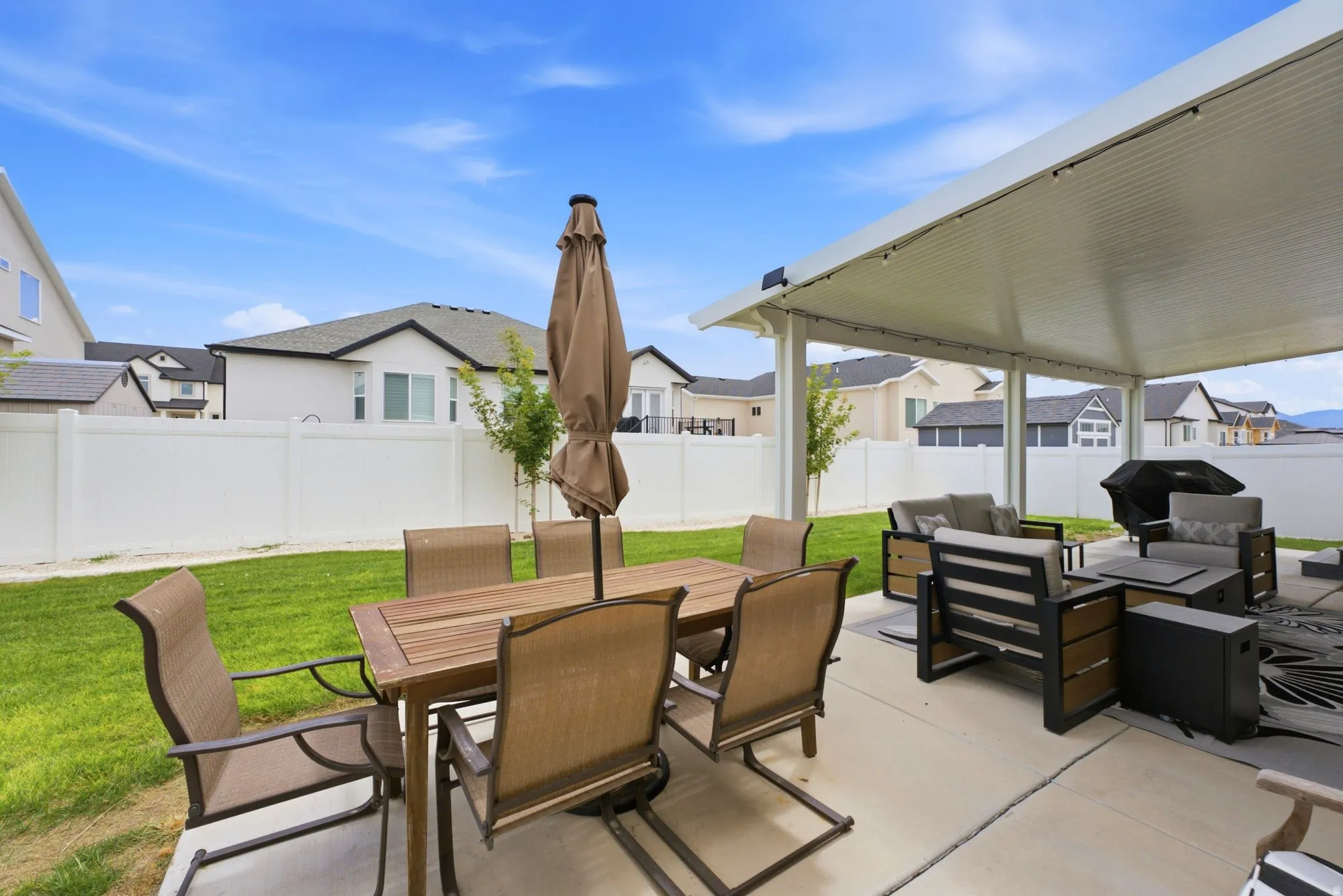 Expansive concrete patio featuring a large covered area with recessed lighting