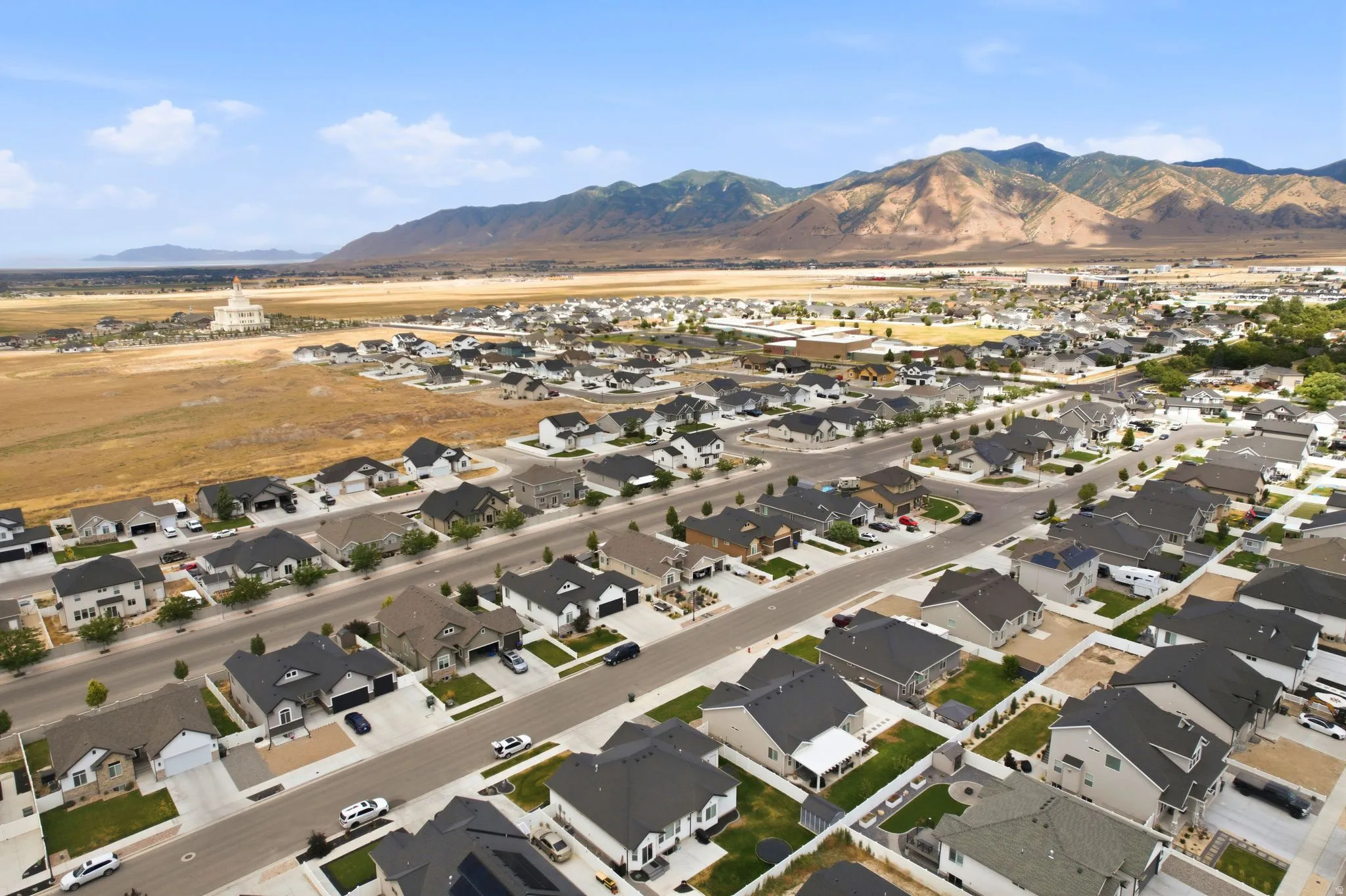 Expansive residential area featuring numerous single-family homes with gray roofs and varied exterior finishes