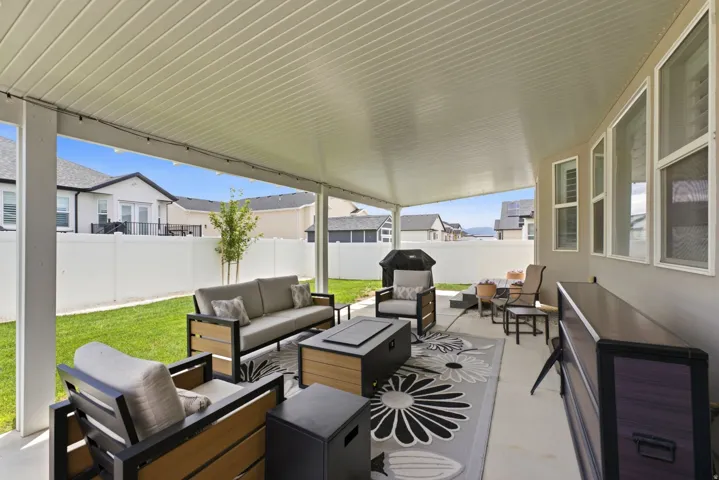 Covered patio with a concrete surface, white paneled ceiling, and recessed lighting