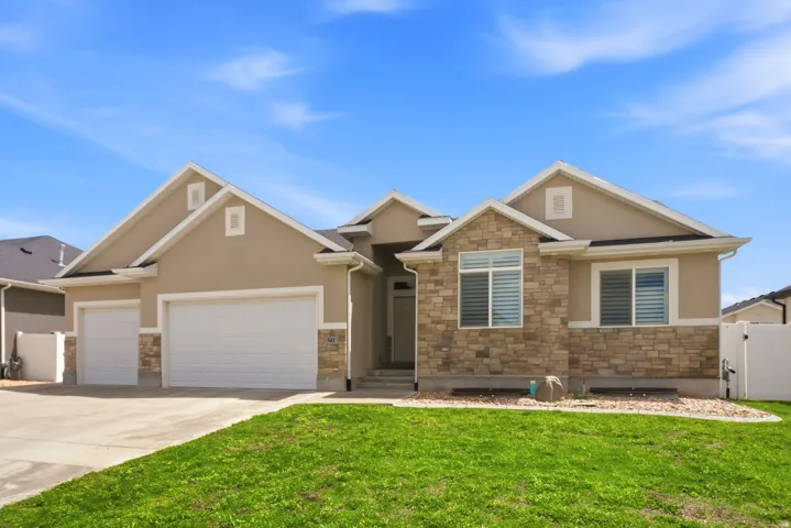 Contemporary stucco exterior with stone veneer accents