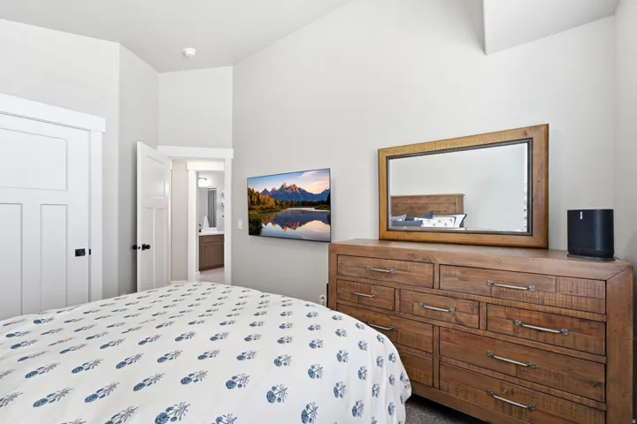 High vaulted ceiling room featuring light gray walls and white trim
