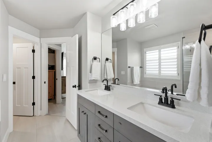 Double vanity with dual undermount sinks, stone-finish countertop, and matte black faucets