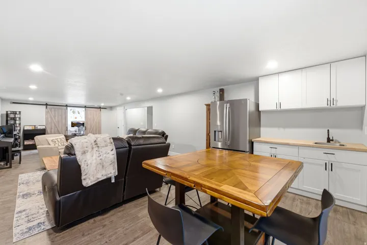 Open concept living area featuring wood-finish flooring, recessed lighting, and a barn door entry