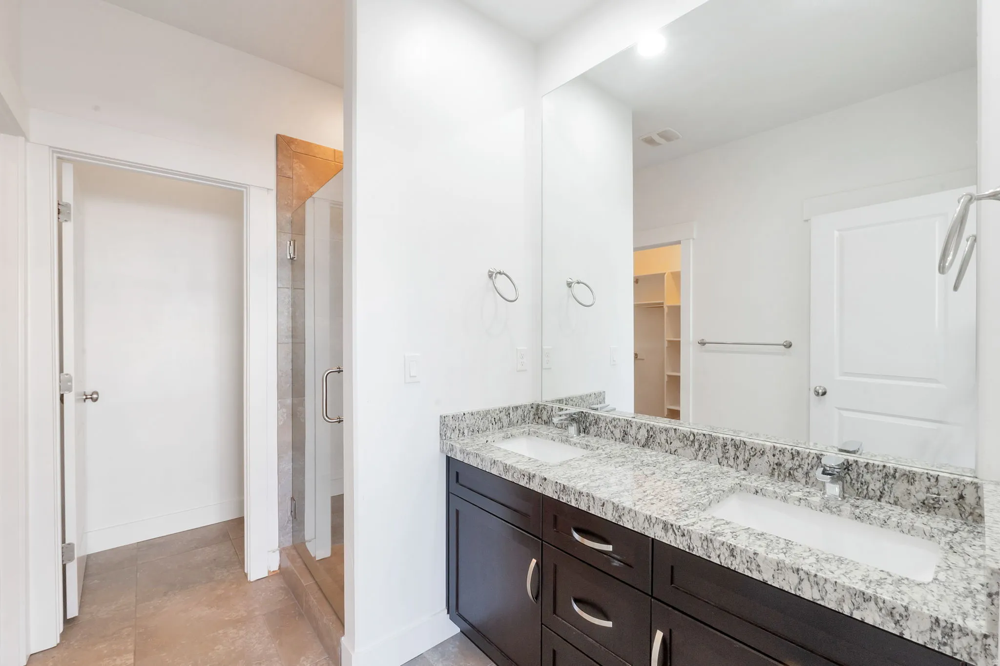 Dual vanity with integrated sinks and a stone-finish countertop
