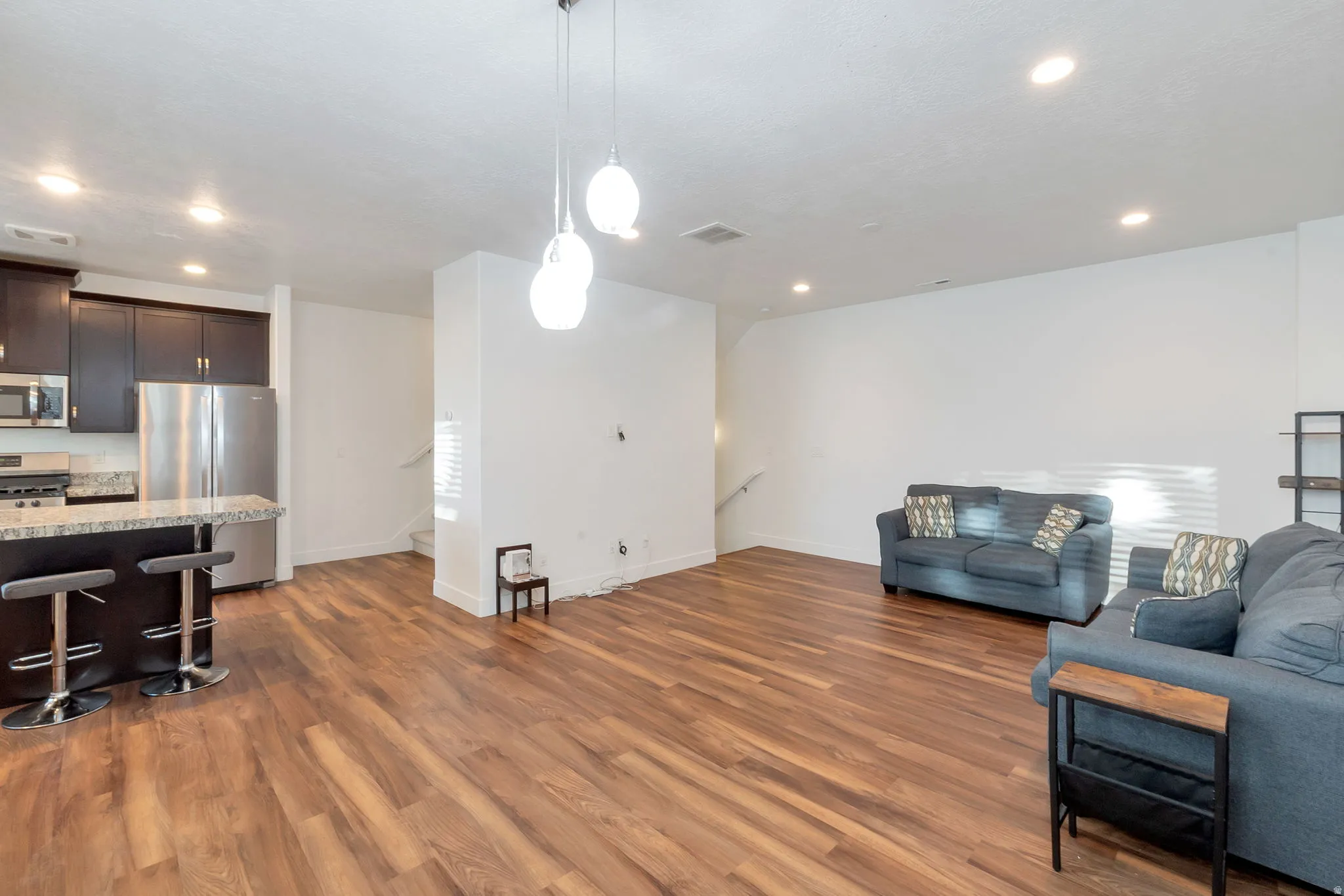 Open-concept living area with wood-finish flooring