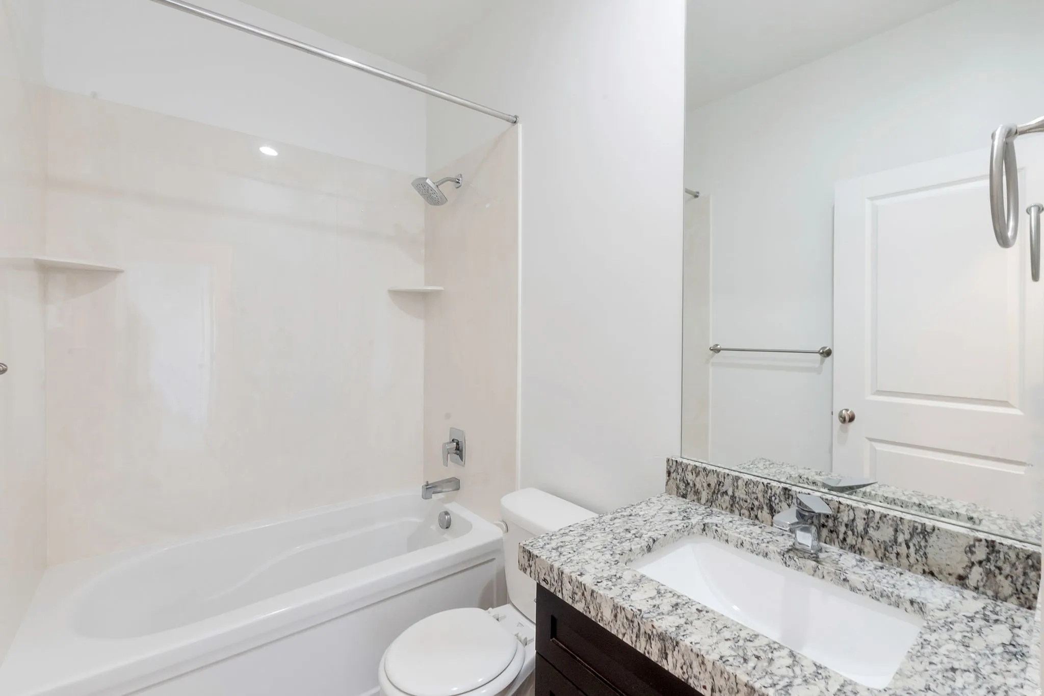 White tub-shower combination with integrated shelving