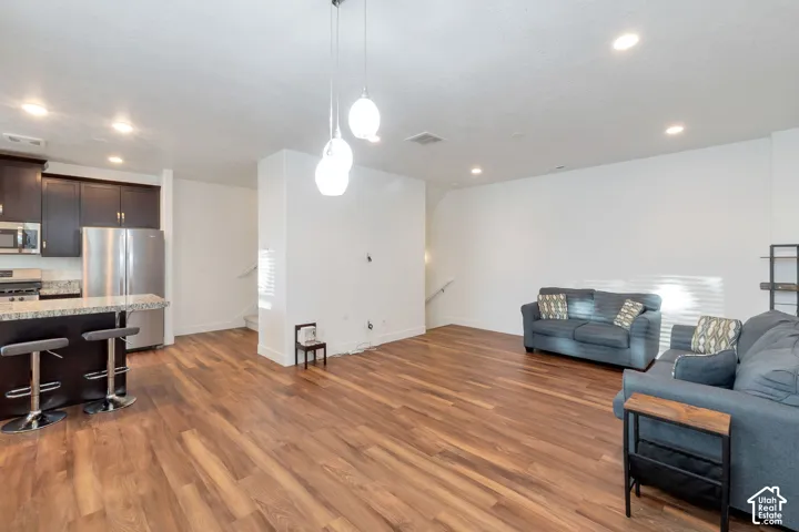 Open-concept living area with wood-finish flooring