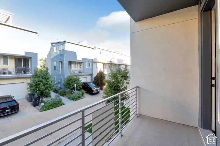 Private balcony with a concrete surface and horizontal metal railing