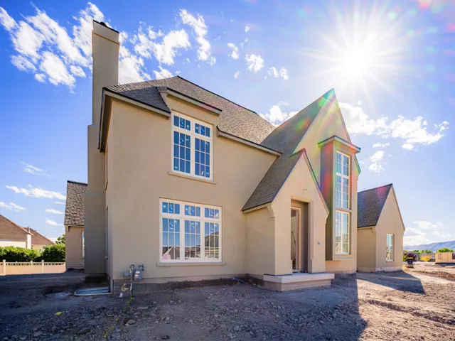 Stucco exterior with multiple gables and a prominent chimney
