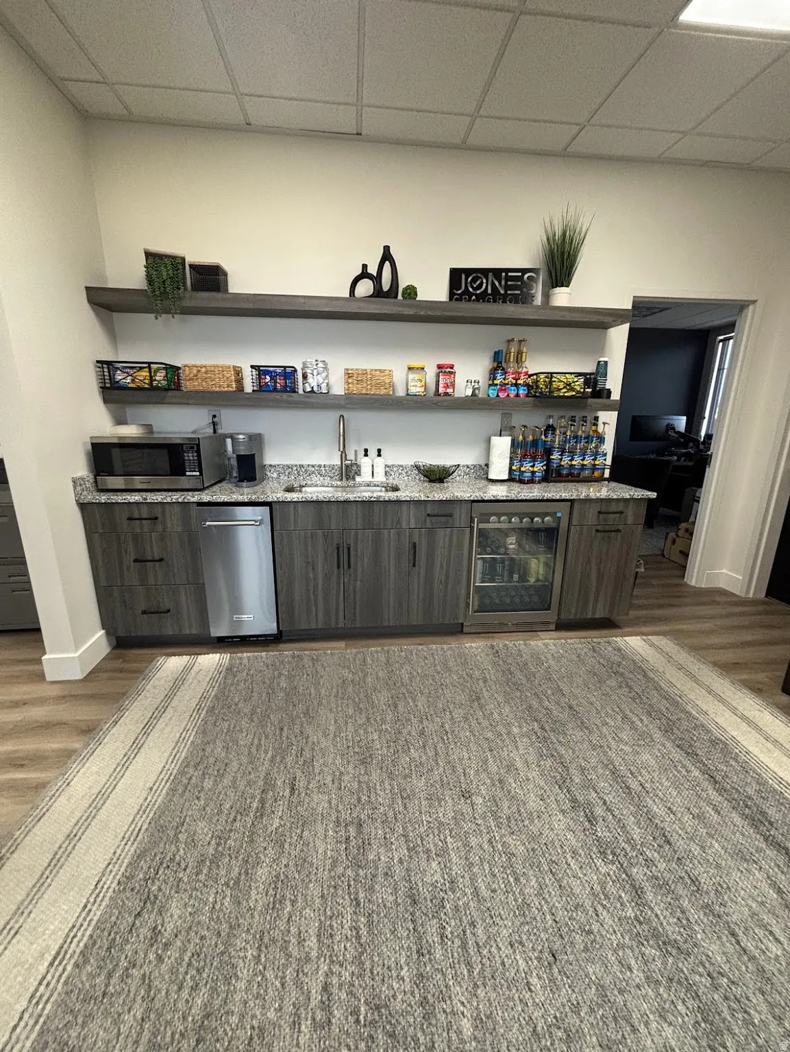 Kitchen bar with mini fridge, sink, ice machine and plenty of storage space.