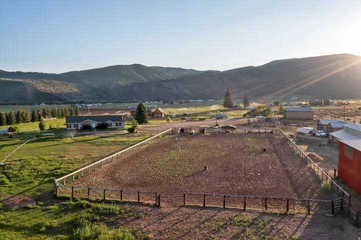 Expansive fenced riding arena with a natural earth surface