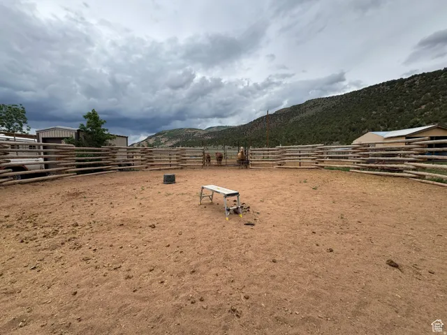 Expansive outdoor arena featuring a rustic log fence perimeter