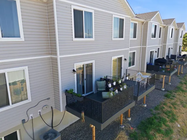 Private elevated deck with black railings and a privacy screen