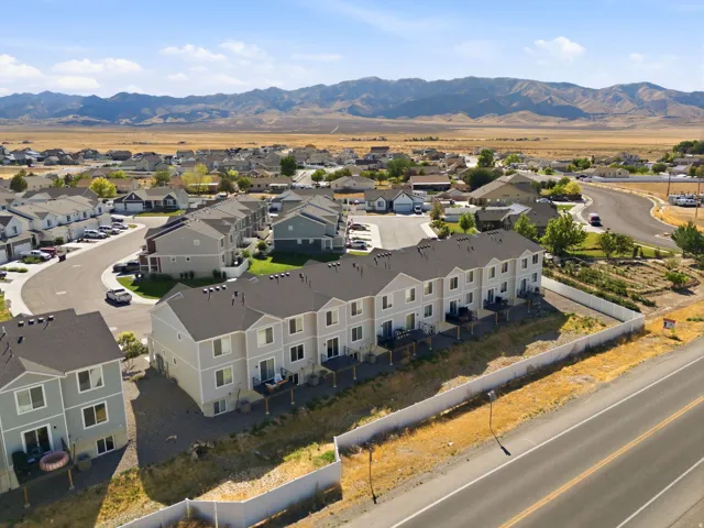 Newly constructed multi-unit property featuring modern light-toned siding and dark shingle roofs