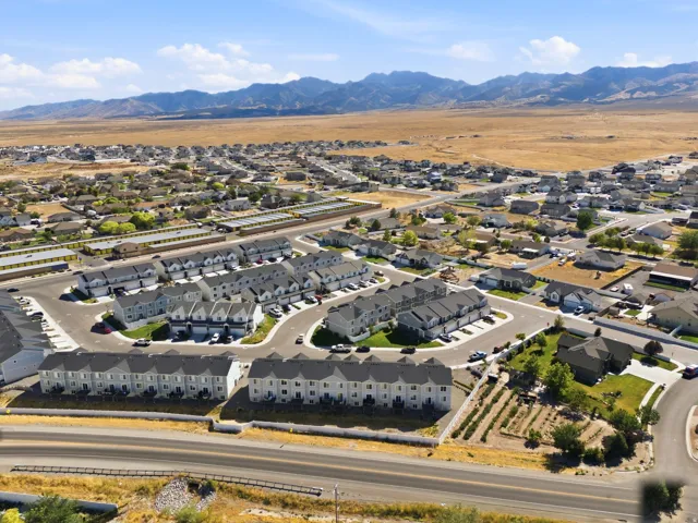 Expansive aerial perspective showcasing a residential community with multiple townhome buildings