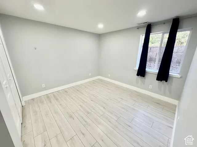 Light-toned wood-finish flooring complements the neutral wall color in this room