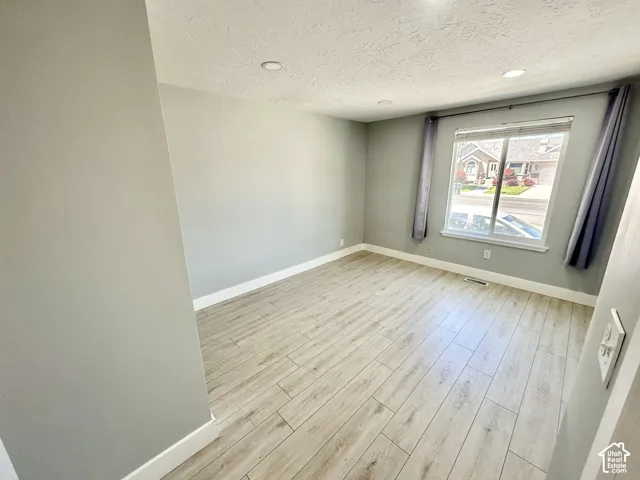 Light wood-finish flooring complements the neutral wall tones in this space