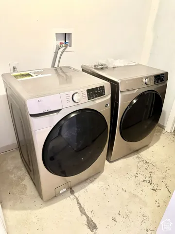 Dedicated laundry area featuring a washer and dryer hookup, light wall paint, and concrete flooring