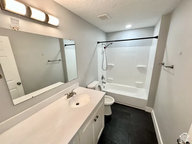 Bathroom featuring a white vanity with an integrated sink, brushed nickel faucet, and a large mirror