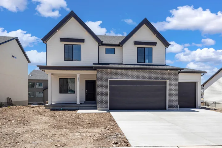 Contemporary two-story exterior featuring white horizontal siding, dark gray brick accents, and a dark gray shingle roof