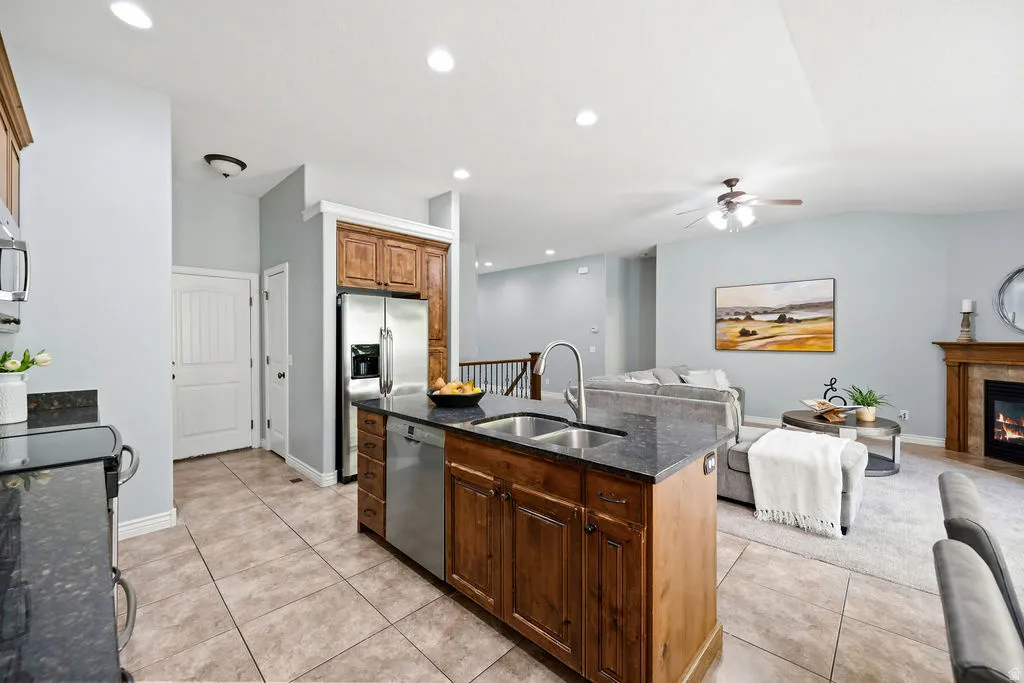 Kitchen island with dual stainless steel sink and dark stone countertop