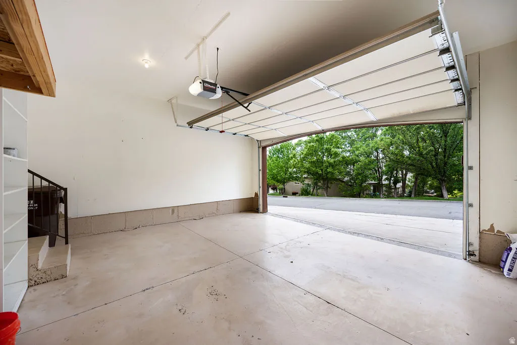 Spacious garage with concrete flooring and built-in shelving