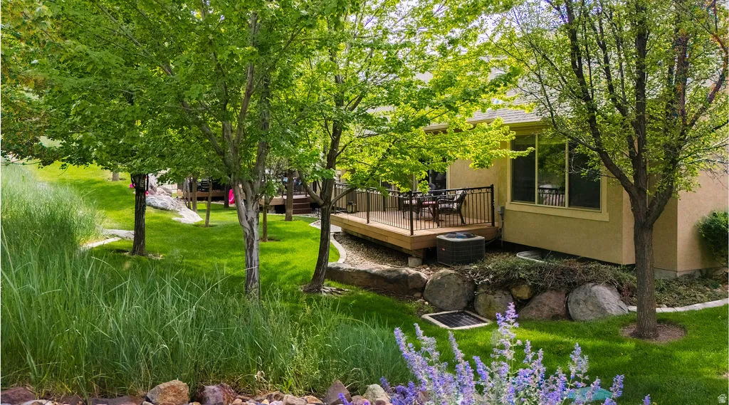 Multi-level wooden deck with black metal railing, offering direct access to the exterior