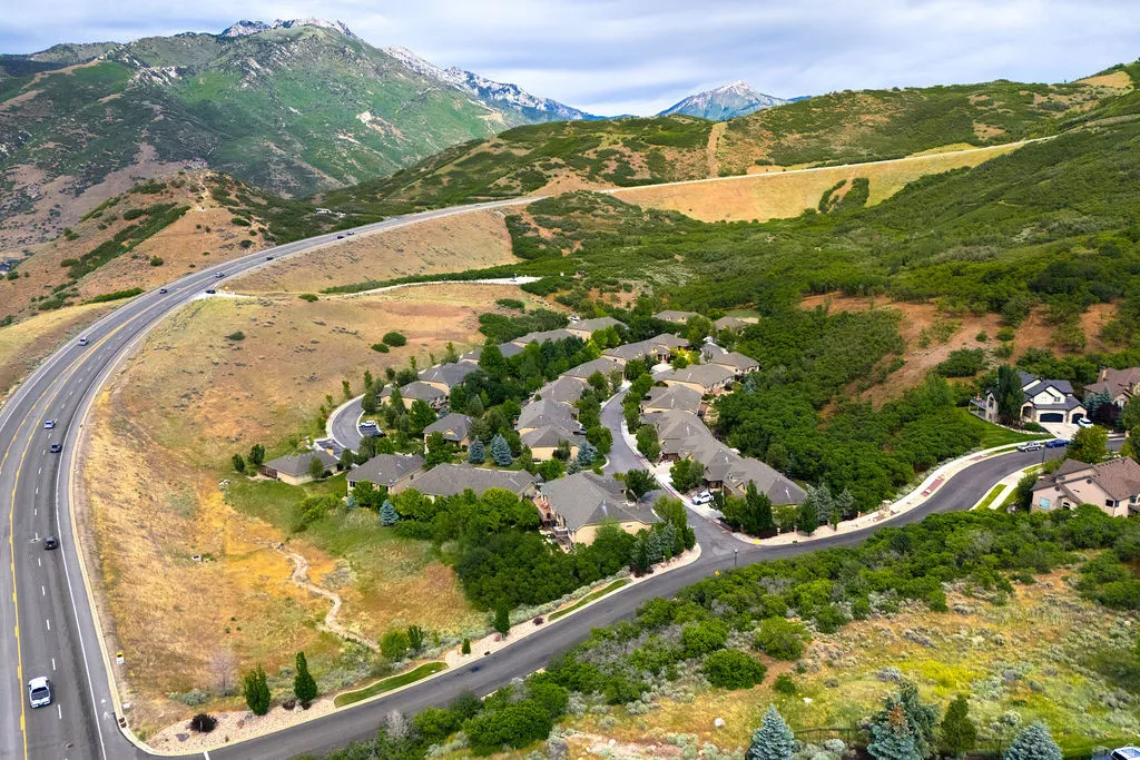 Residential community nestled into a mountainous landscape with mature trees