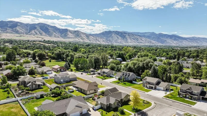 Expansive residential area featuring numerous single-family homes, mature trees, and paved streets