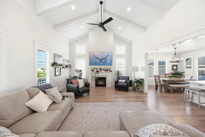 Vaulted ceilings with exposed beams, recessed lighting, and a modern ceiling fan