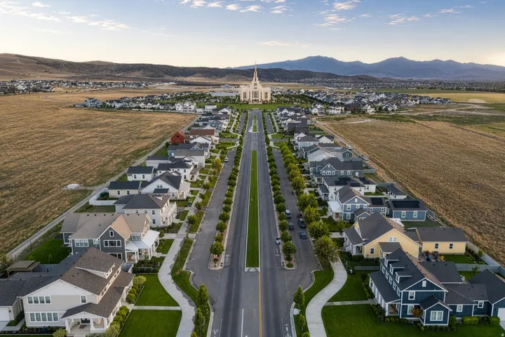 Residential community featuring a variety of single-family homes with diverse architectural styles, tree-lined streets, and manicured lawns