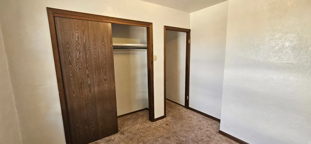 Built-in closet with wood-finish sliding doors and interior shelving