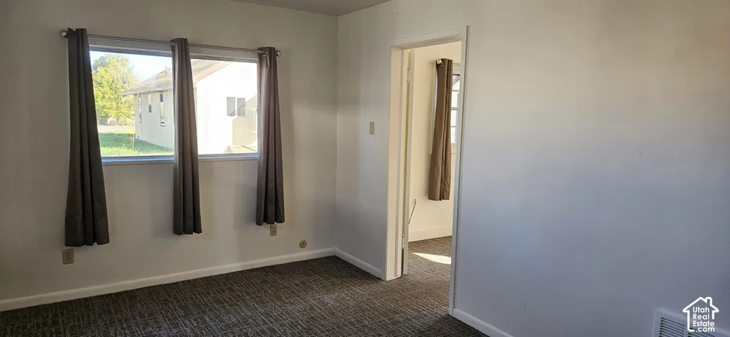 Neutral-toned interior featuring textured carpeting and dual-pane windows