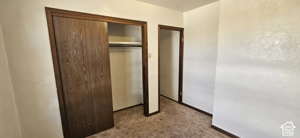 Built-in closet with wood-finish sliding doors and interior shelving