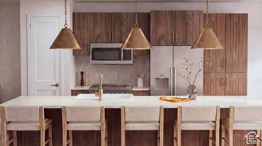 Kitchen island with light-toned countertop and integrated sink